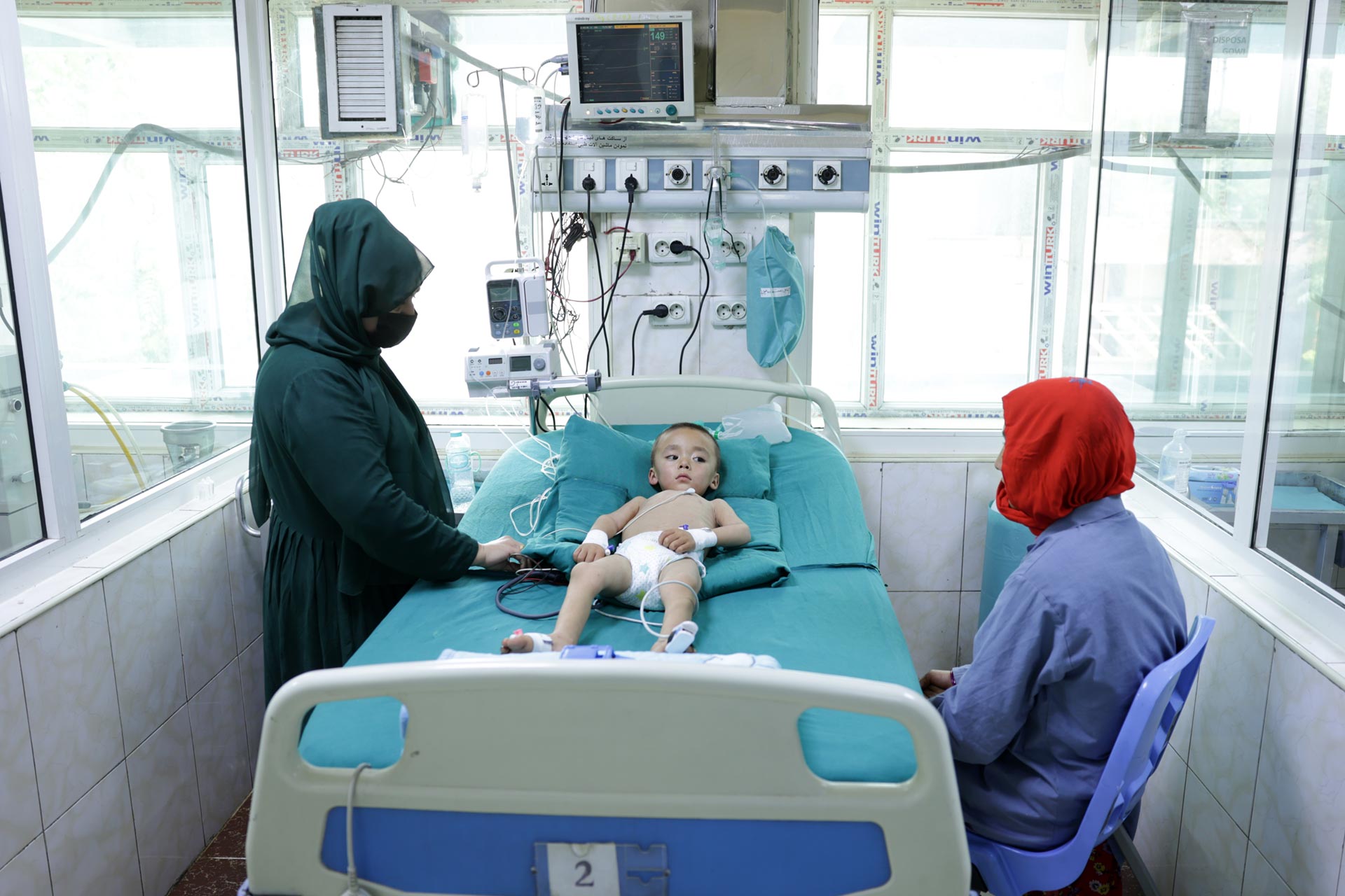 A young child rests in the ICU at Indira Gandhi Institute of Child Health in Kabul, receiving critical care and oxygen therapy