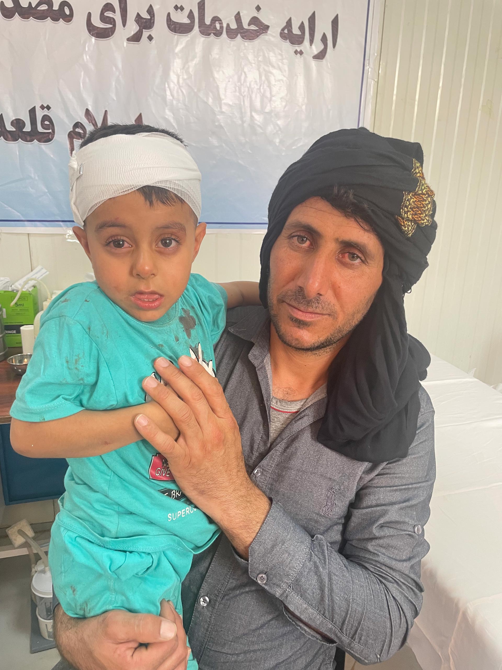 Akmal Younus and his father after Akmal had been treated. Photo credit: WHO