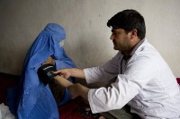 A doctor measuring the blood pressure of a patient