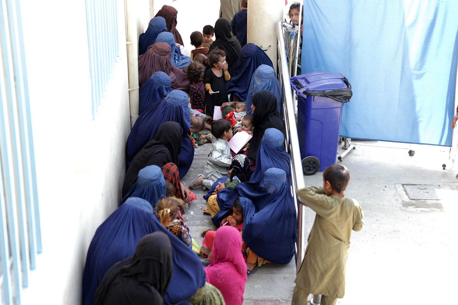 Women and children wait to receive essential health and humanitarian services at the Zero Point border in Nangarhar province on 12 May 2025. Photo credit: WHO