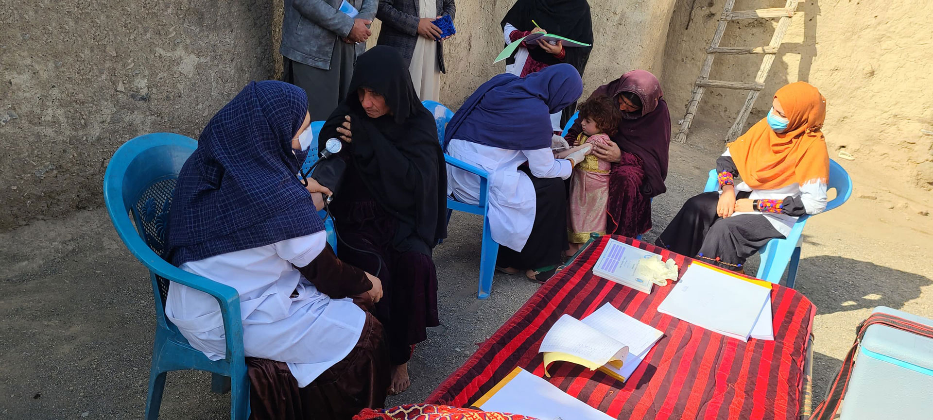 Women health workers providing essential care and vaccinations in a remote community clinic