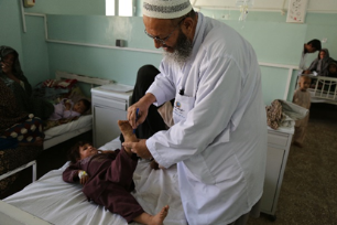 AFP focal point examines a child in Mirwais Hospital in Kandahar