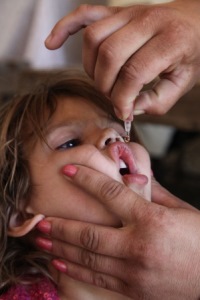 Child receiving an oral polio vaccine