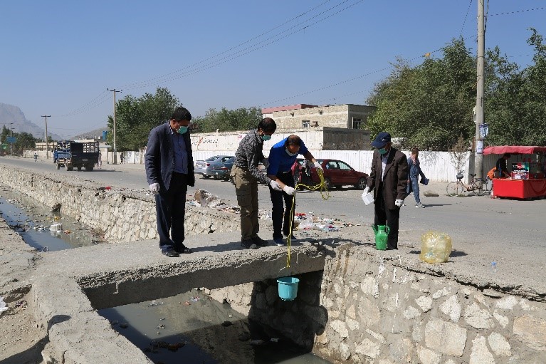 Environmental sampling from an open drain in Kabul city in August 2017. Samples are generally collected in the early morning when there is a higher flow of sewage. WHO/S.Ramo