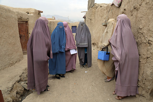 Zainab (left) meets with one of her vaccinator teams. This team has vaccinated 49 children today, and it is only 9.30 the morning.