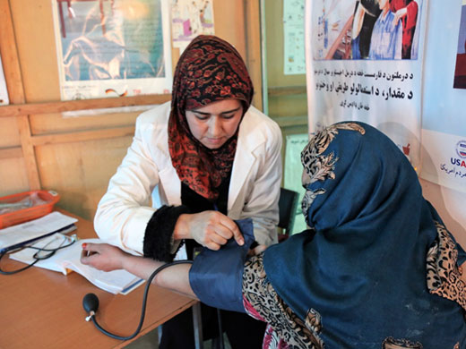 Credit: WHO Afghanistan/S.Ramo 30-year-old Halima from Baghlan province gets a post-pregnancy health check-up at the clinic in the Nasaji Bagrami IDP camp. She has been living in the camp for 7 years. Women in the camps rely on the health services provided by the mobile clinics as the nearest government-run hospitals are often far away and not accessible due to cultural and security reasons.