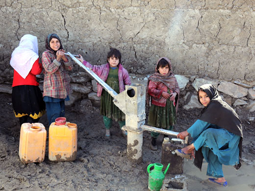 Credit: WHO Afghanistan/S.Ramo Children fetch water from a pump near the mobile clinic in the Nasaji Bagrami IDP camp. Most camps do not have electricity, running water or proper sanitation facilities. WHO is grateful for the support of USAID, ECHO and CHF that enabled the provision of essential health services for tens of thousands of Afghans in these camps for the past months. All 17 mobile clinics were closed in May 2017. With the support of WHO, the Ministry of Public Health is currently looking into alternative ways of supporting these much-needed essential health services for IDPs living in the camps.