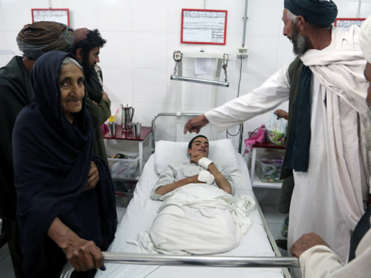 Credit: WHO Afghanistan/G.Elham 60-year-old Nazo stands at the bedside of his grandson Rahmatullah, 19, who was badly injured by a roadside bomb in Lashkar Gah. Rahmatullah lost both of his legs in the blast, and received treatment at the Surgical Centre. “There is a fight going on everywhere and you can hear gun shots from everywhere. I fear that peace will never come,” Nazo says.