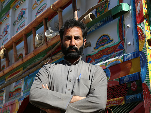 Photo credit: WHO Afghanistan/S.RamoJamil Rahman leans on his colorful truck at the Torkham border crossing as he watches as his children get vaccinated by polio teams working at the “zero point” border crossing area that has a temporary basic health centre providing vaccinations, nutrition screening and counseling on infant and young child feeding practices as well as vitamin A and deworming tablets for children. “We have lived in Pakistan for 40 years – here we don’t have a house or anything else. I was a mathematics teacher in Pakistan but now I hope to find some work in the agricultural sector. I have 2 sons and my biggest hope is that they grow to be healthy and get to go to school,” Jamil Rahman said.