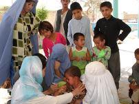 A child receives a measles vaccination during WHO's post-disaster campaign in flood-affected provinces