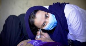 Midwife Shakila listens to a baby's heartbeat in a WHO-supported mobile clinic in Bamyan