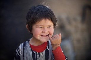 A girl shows her pinky finger marked with indelible ink after receiving the polio vaccine