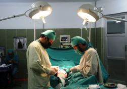 Surgeons operate on a patient at the WHO-supported emergency surgical centre in Lashkargah Helmand province