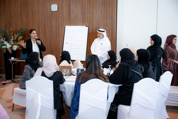 Ms Inas Hamam, Emergency Communication Manager, interacts with participants during a group work exercise on planning and implementing effective communication and engagement strategies. Photo credit: WHO/WHO Bahrain
