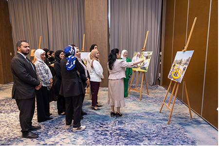 Dr Wafa Alsharbati, Dr Tasnim Atatrah and participants explore the Healthy Cities Photography Exhibition. Photo credit: WHO/WHO Bahrain