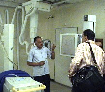 Biomedical engineers inspecting an X-ray machine