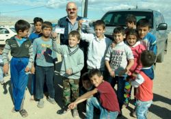 A_group_of_children_hold_up_information_leaflets_on_cholera