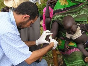 A laboratory technician taking a blood sample from a woman