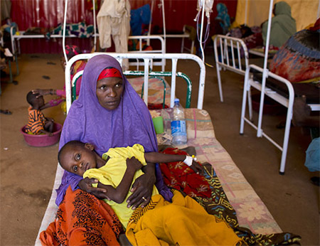 Hawa Ibrahim holds her 10-year-old son Andi Nassir, who was suffering from acute watery diarrhoea, in the stabilization centre for malnourished children, in Baidoa during last year’s cholera outbreak.