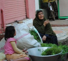 A pavement pedlar selling leaf vegetables 