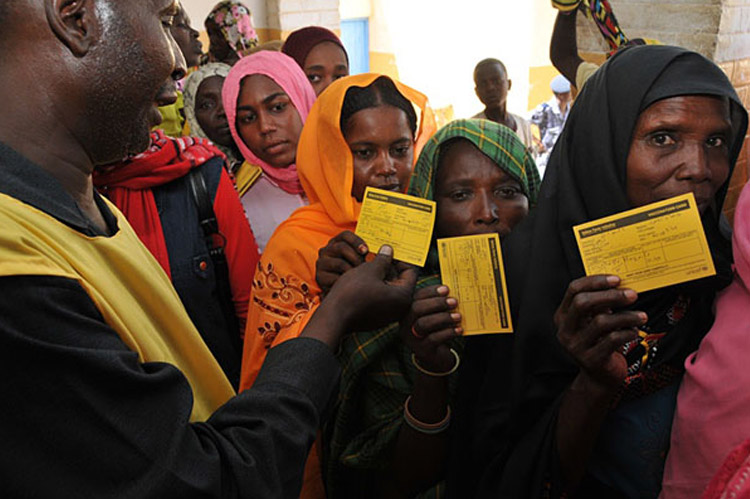  A group of people hold up their yellow fever vaccination cards in Darfur, Sudan (Photo: WHO Sudan)