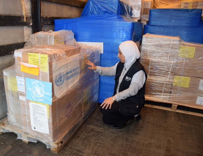 Dr Tasnim Atatrah of WHO Gaziantep checks boxes holding supplies to treat noncommunicable diseases like asthma, diabetes, and hypertension. WHO Gaziantep ships the supplies from Turkey to clinics in northwest Syria. Photo: WHO/Sheahen