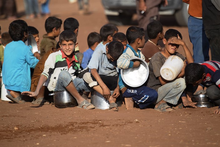 Group_of_boys_wait_for_water