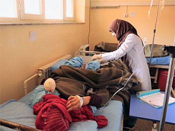 Nurse Nooria attends to a patient at the unit where she has worked for the past 6 months, providing pre- and post-operation care, checking on patients, taking care of patients’ relatives and distributing medicines