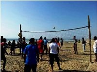 Men playing volleyball on the beach