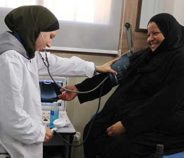 A health worker checks a patient’s blood pressure at Maskaneh Health Centre in rural Aleppo. The facility delivers primary health care services through a WHO-supported implementing partner, ensuring access to essential care for communities in hard-to-reach areas