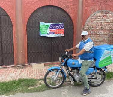 A vaccinator from Lahore, Pakistan, on one of the motorbikes handed to the Expanded Programme on Immunization by WHO. Photo credit: WHO