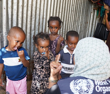 Somali children show their marked fingers after receiving oral polio vaccine, a sign they’ve been protected during a door-to-door vaccination campaign