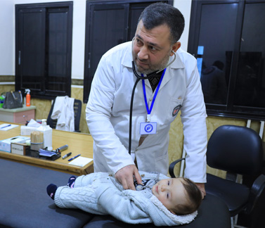 Four-month-old Walid receives treatment for severe cold symptoms at Kurin Health Center, supported by WHO through CERF to ensure continued pediatric care