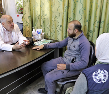 Molham, 22, consults his doctor at the National Hospital in Hama where he receives free insulin, provided by WHO with support from KSrelief