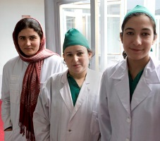 Three midwives smiling at the camera