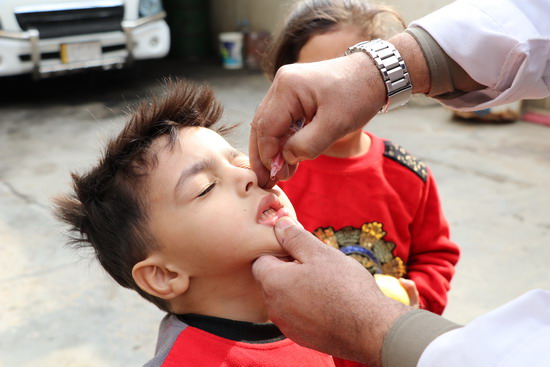 Child recieves oral polio vaccine in Baghdad