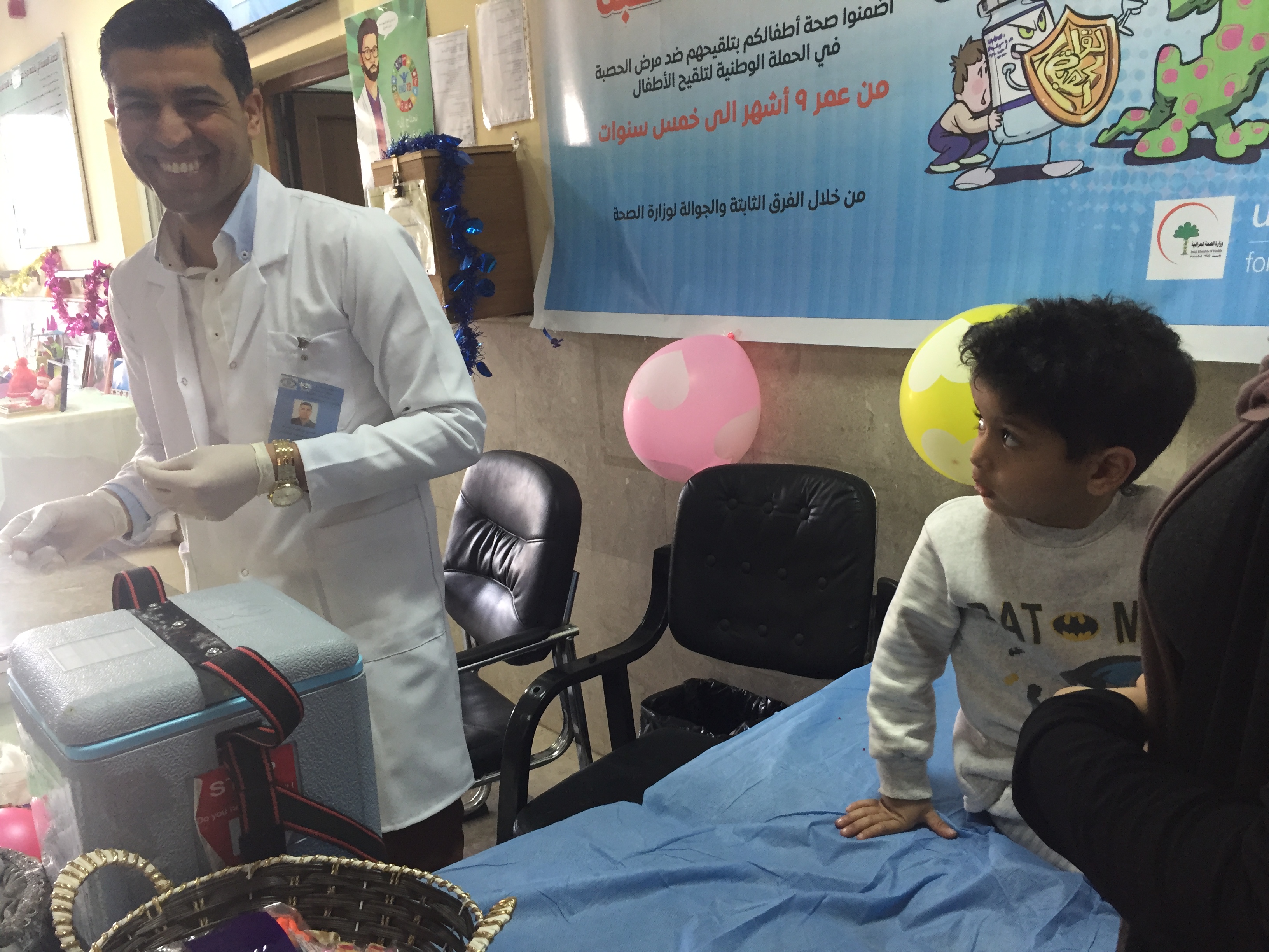 A child waits to receive his vaccination at a health centre in Baghdad