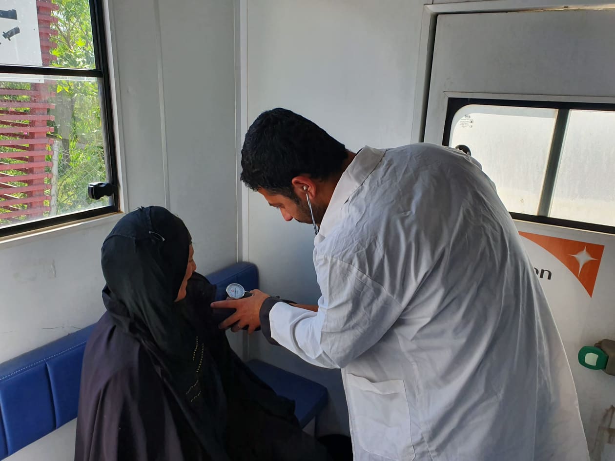 A doctor takes the blood pressure reading of a patient in WHO supported MMC in Qoratu