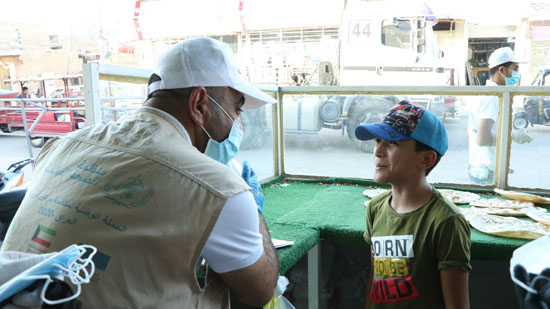 Ahmed Ali  speaking to one of the volunteers reaching communities in hard to reach areas