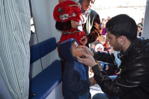 Dr  Yousif Mohammed Ali examines a young girl at a mobile medical clinic in Kebirto IDP camp 1. Photo: WHO/P Ajello