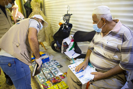 Khudir recieved a face mask from the sensitization team educating people of COVID-19 in Basra city