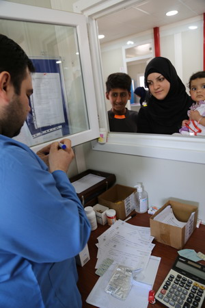 A patient receives medicine at a health facility in Qayara supported by one of the health cluster partner 