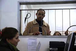 Hammad presents his prescription for medication at JHAS clinic. Photo credit: WHO/J Swan