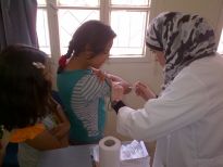 A young girl is vaccinated against measles as part of the vaccination campaign in Irbid and Mafraq