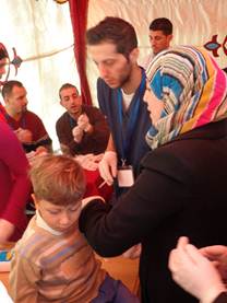 Young child is vaccinated by medical staff