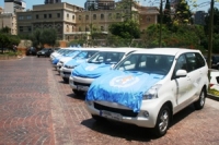 A row of donated vehicles with WHO logo provided to the Ministry of Public Health of Lebanon