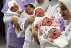 Nurses holding newborns