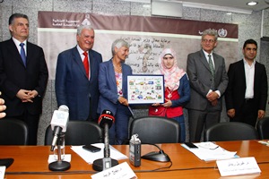WHO representative Dr. Riedner presenting the prize to the winner of the World Health Day art competition