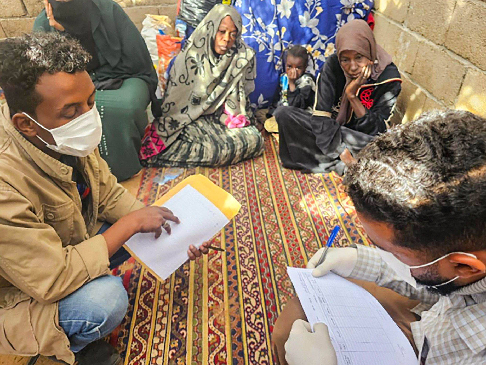 Health workers in Libya conduct a needs assessment with displaced families to ensure access to essential services and humanitarian support