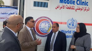 WHO Representative and colleagues by a mobile clinic